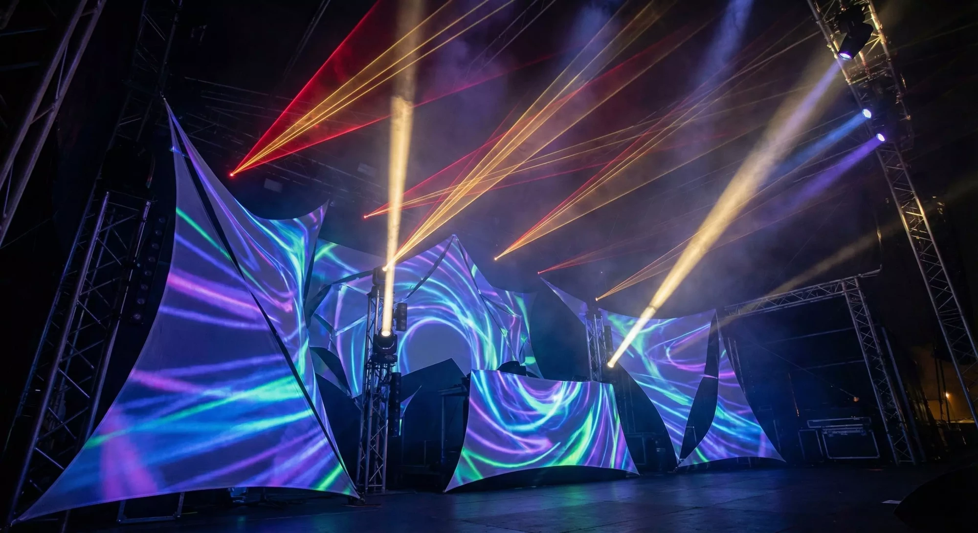 Stage projection and lighting interacting with controlled atmospheric haze.