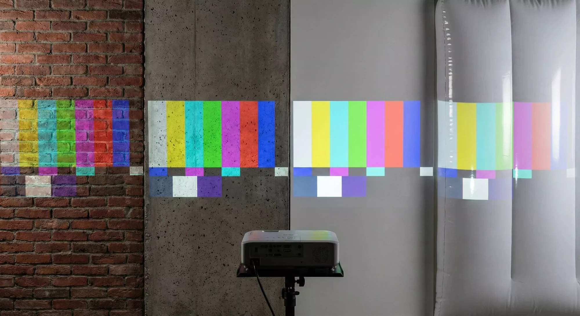 Different projection surface types illuminated for comparison.