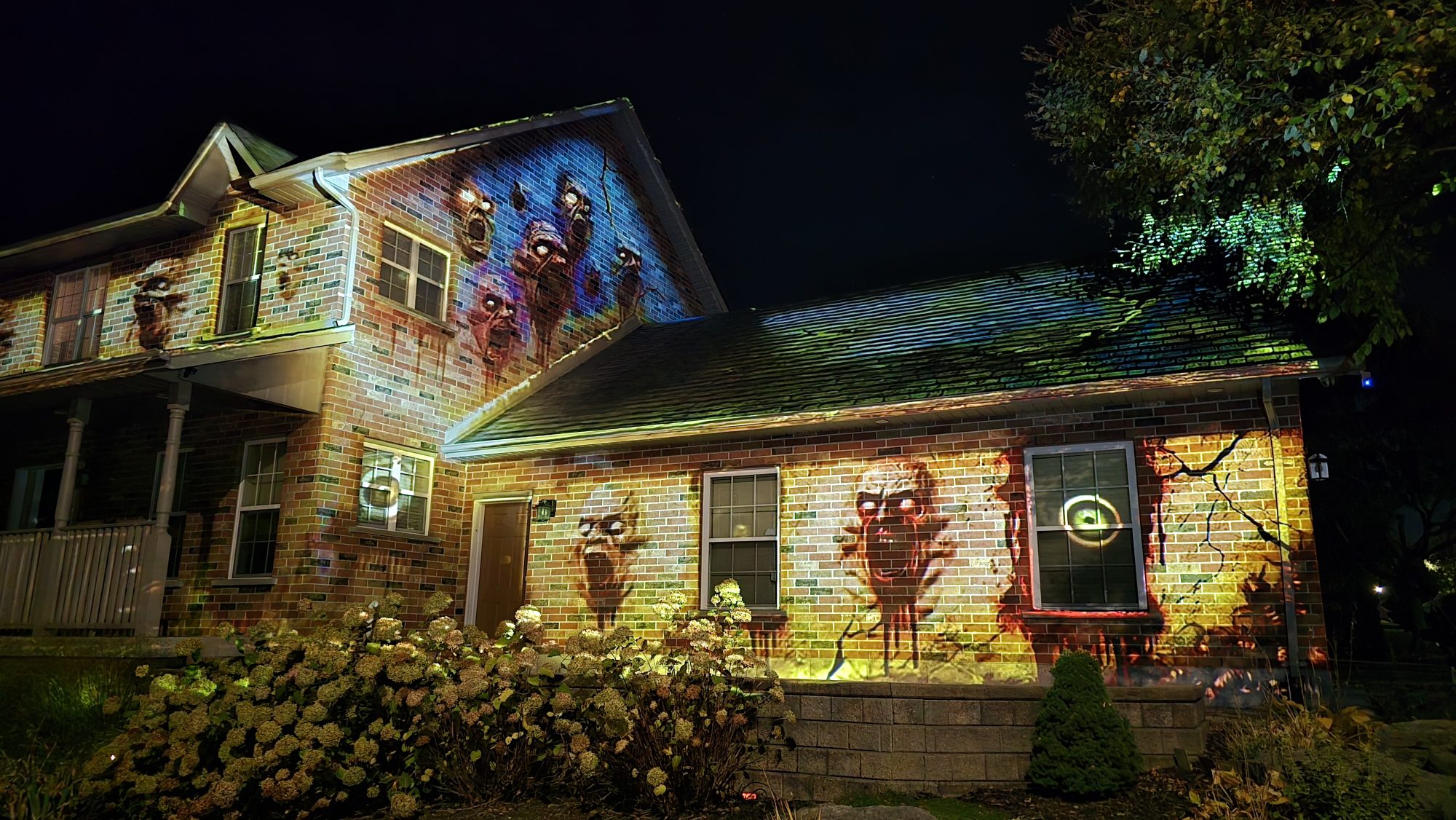 A Barrie home illuminated with colourful ghost projections at night